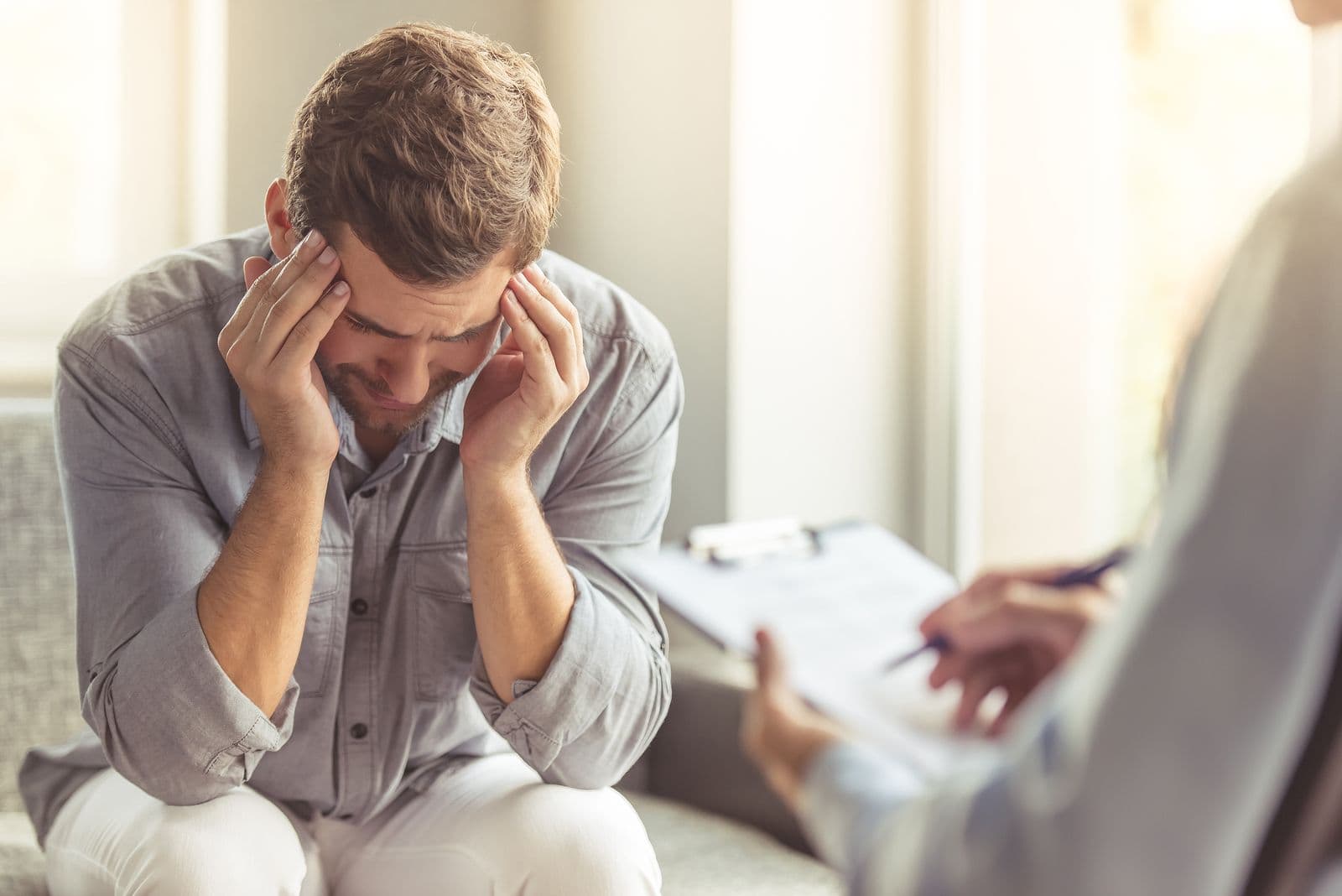 Woman sitting quietly by a window, reflecting during anxiety therapy in Omaha