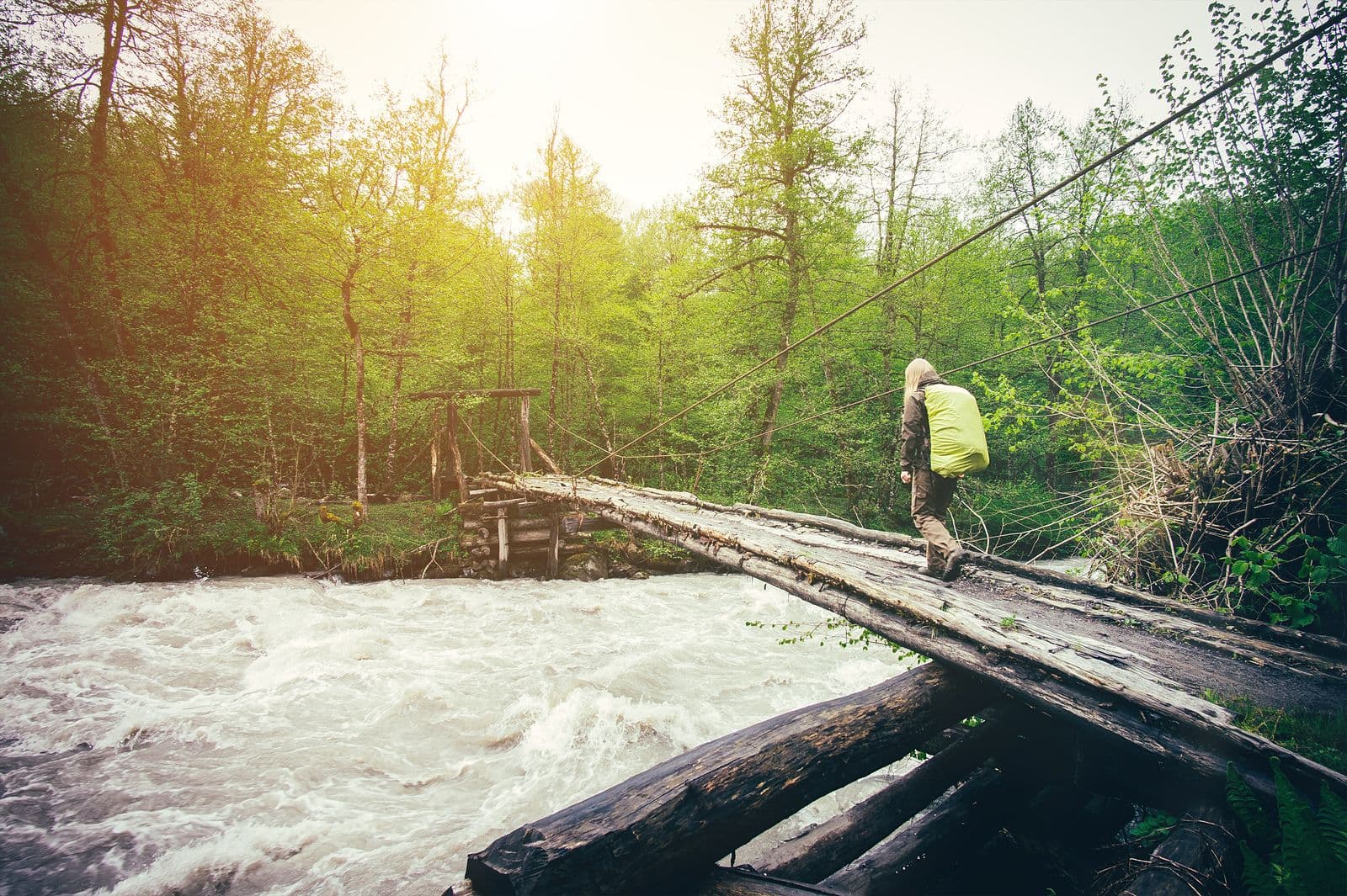 Person crossing a river on stepping stones, a picture of moving forward after divorce