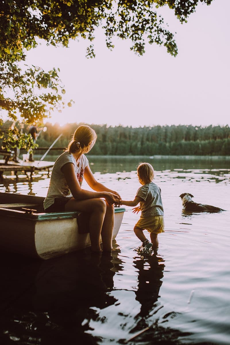 Parent and child sitting by the lake, finding calm after divorce in Omaha